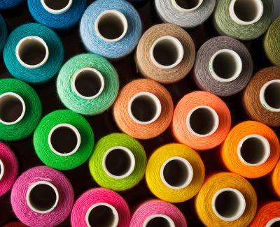 Sewing threads multicolored background closeup